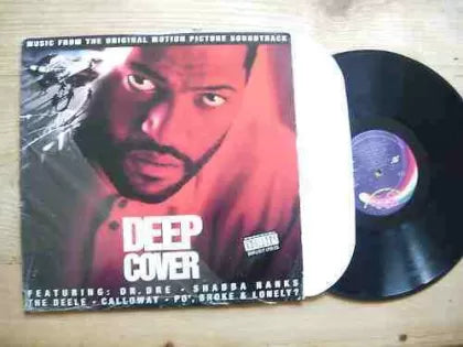 Vinyl record and cover titled 'Deep Cover' on a wooden surface