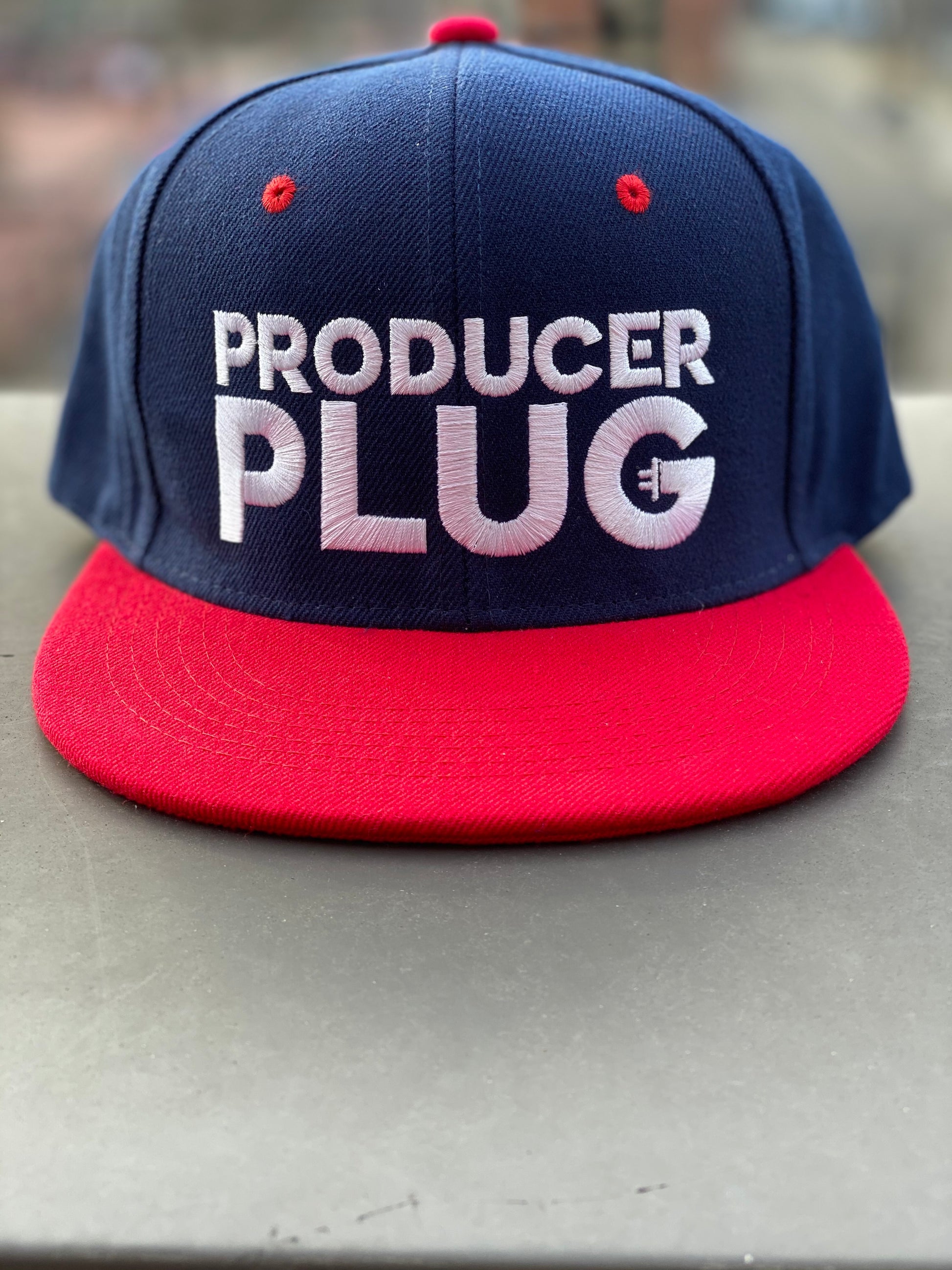 PRODUCER PLUG NAVY W RED BRIM SNAPBACK (WHITE TEXT)