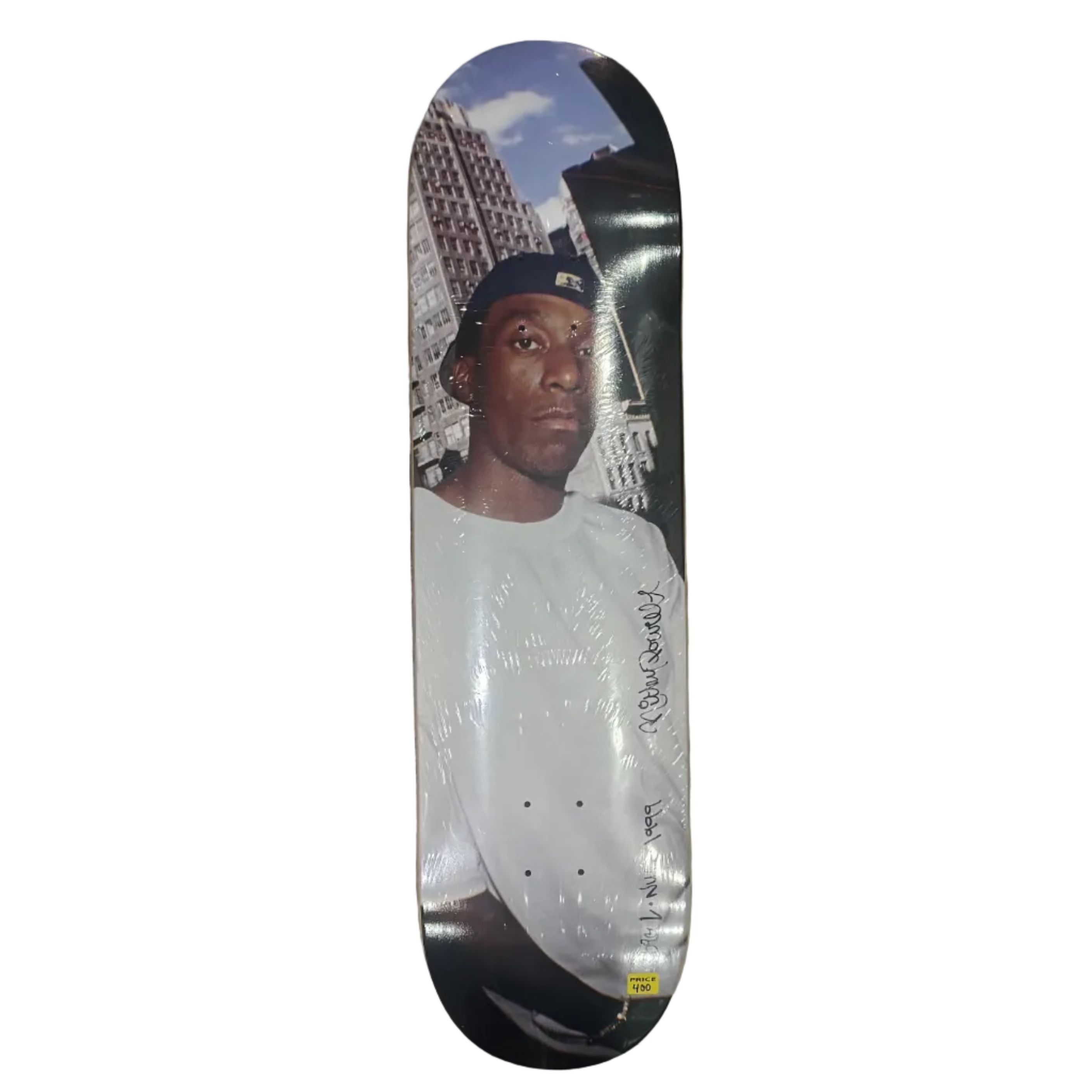 Skateboard with a printed design of Big L by Ricky Powell